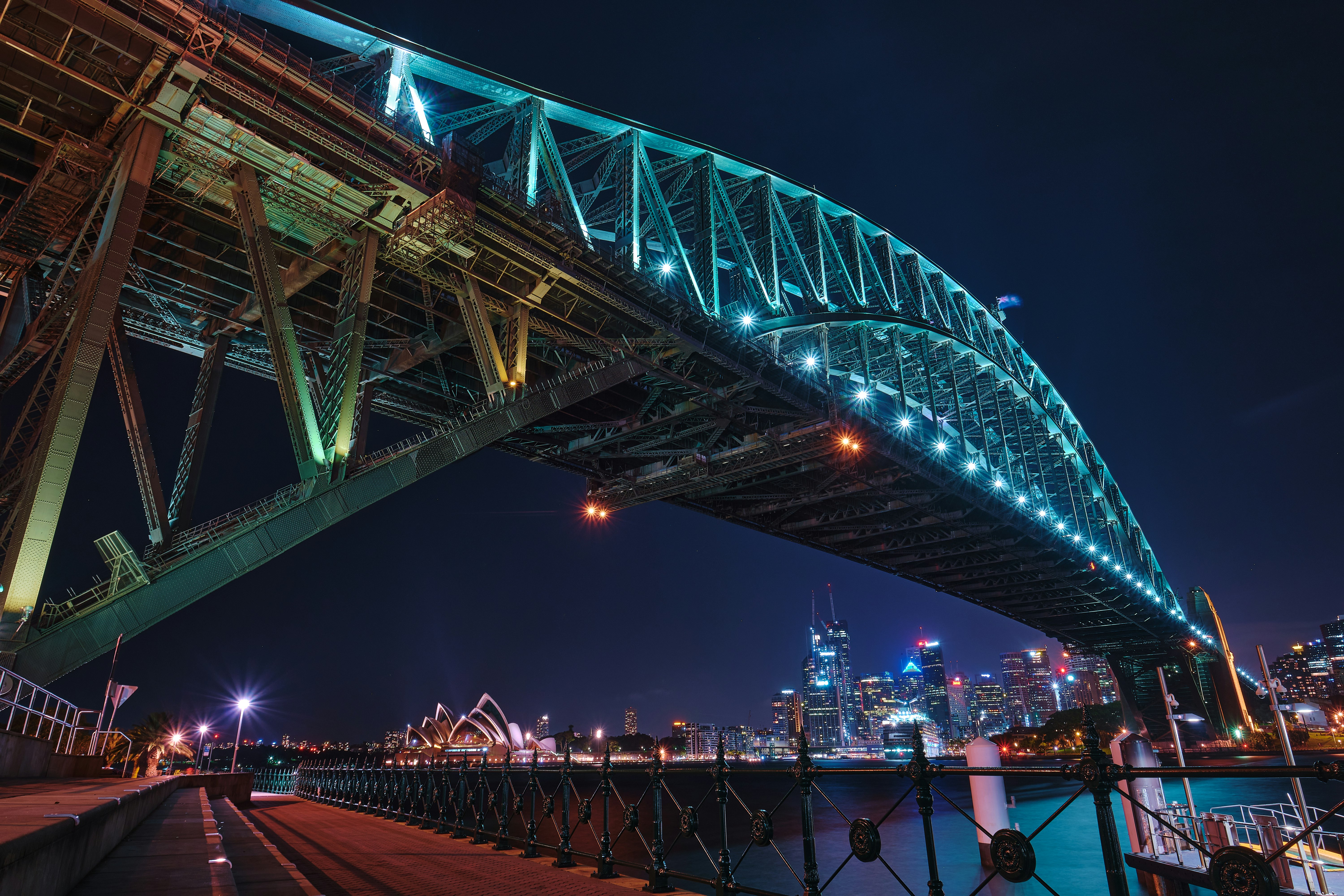 people walking on bridge during night time